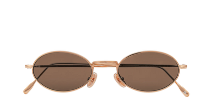 Vista frontale degli occhiali rotondi modello Marie, con montatura oro rosa e lenti color marrone scuro, chiusi