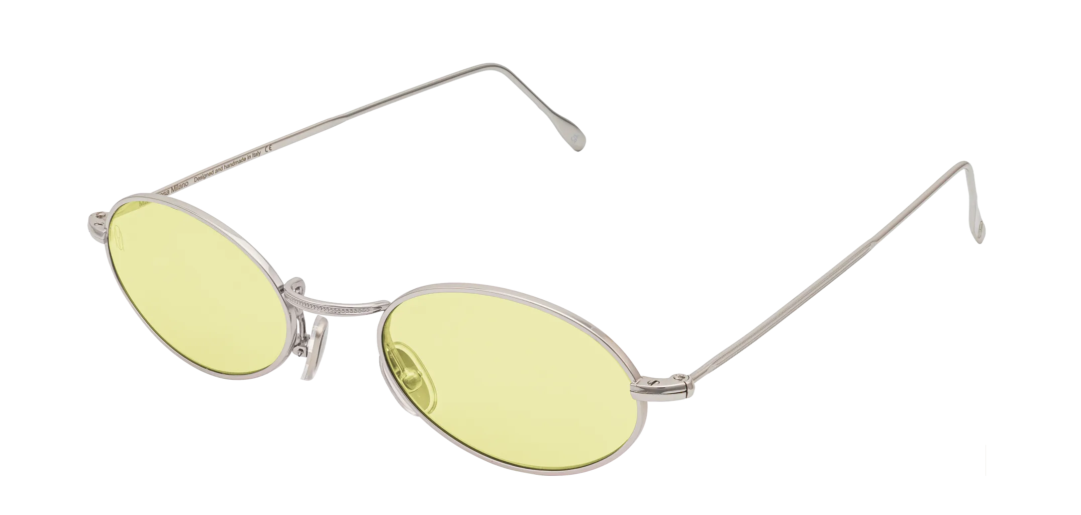 Vista a tre quarti degli occhiali rotondi modello Marie, con montatura argento e lenti color giallo, aperti